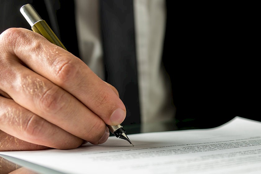 Mann bearbeitet KnowHow zum Download mit dem Stift am Schreibtisch