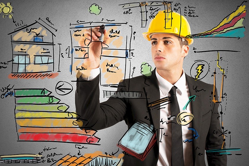 Mann mit Baustellenhelm malt verschiedene Symbole im Zusammenhang mit der Baubranche